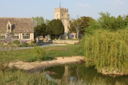The duck pond, Ducklington, with St. Bartholomew's Church behind Wallpaper