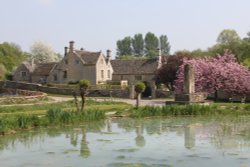The manor house and village pond in Westwell