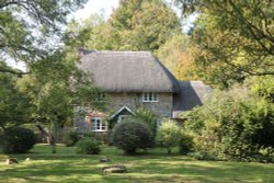 Sarsen stones and a period cottage at Lockeridge Dene Wallpaper