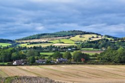 Cottages at Broome with Iron age Hillfort in the background. Wallpaper