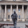 A statue in front of Huddersfield Railway station