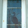 Broadstairs. Stained glass window of Bleak House. Unfortunately the second of the pair is damaged.