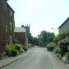 Thrussington street with All Saints Church in the background