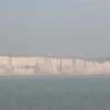 Misty View of the white cliffs of Dover with - the Lighthouse in the background