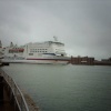 A cross channel ferry sqeezing into the harbour mouth, taken from Spice Island.