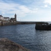 Porthleven, Cornwall. The harbour mouth, the clock tower is part of the old library.