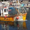 Fishing boat leaves harbour at Lyme Regis.