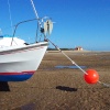 The harbour at Wells-next-the-Sea at low tide. RNLI lifeboat house in the distance.