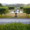 Fountain on the lawn at Chatsworth House, Derbyshire with Edensor village church in the distance