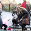 Greater London. Portobello Road. Cheering up the Busker.