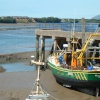 Fishing boat awaiting the tide in Walney Channel at Barrow in Furness, Cumbria.