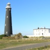 The old lighthouse, Dungeness, Kent, sits comfortably in the very distinctive landscape.
