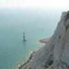 The lighthouse at Beachy Head, East Sussex, dwarfed by the while cliffs above it.
