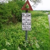 Ageing Slow sign at a crossroads on Clyro Hill in Radnorshire, Powys