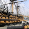 HMS Victory is guarded by a row of cannons along the dockside at Portsmouth, Hampshire