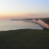 The Seven Sisters bathed in pink light at sunset, seen from Birling Gap
