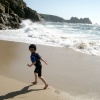 My son enjoying the waves at Porthcurno