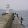Anglers take advantage of an evening high tide at Mevagissey, Cornwall