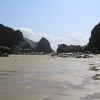 Brooding rocks and rivers of water on the beach at Bedruthan Steps, Cornwall, show the tide is never far away