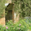 Old walls support climbing plants at Sissinghurst castle garden, Kent
