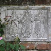 A wall plaque of three kings at Sissinghurst castle gardens