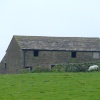 An old stone farmhouse on the top of the hill
