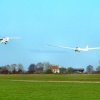 Glider being towed by Piper Super cub