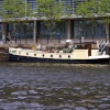 There are lots of narrow boats moored along the river banks.