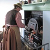 Stoking the kitchen stove at Blists Hill, Shropshire