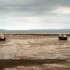 Boats sitting on the mud.