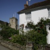 Cottage in village with  flowers and Church