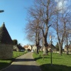 Village Green at Harrold, Beds. The village keep is the round building on the left.
