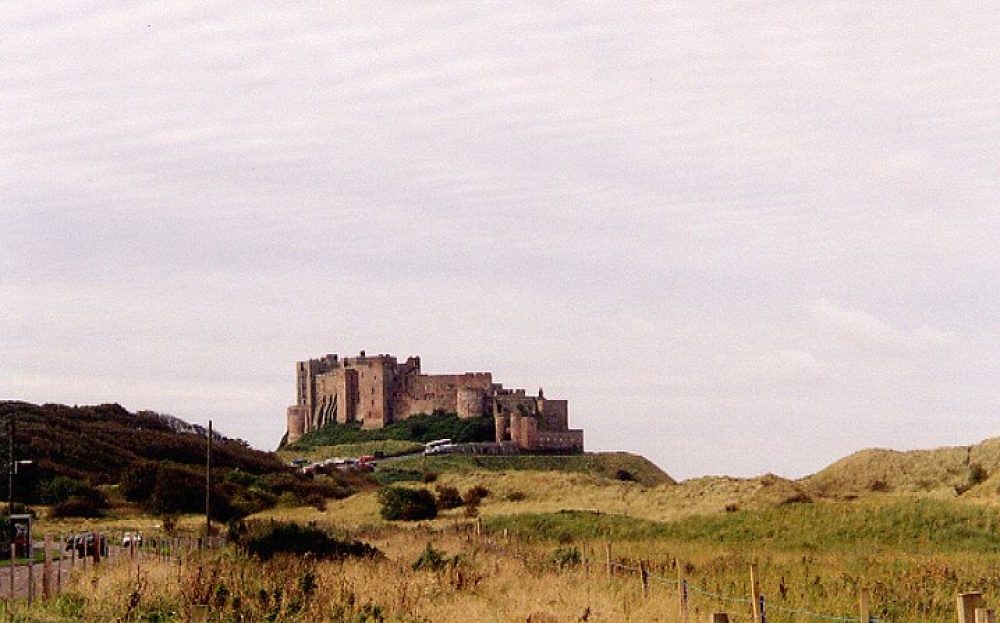 View of Bamburgh Castle from approaching coastal road.