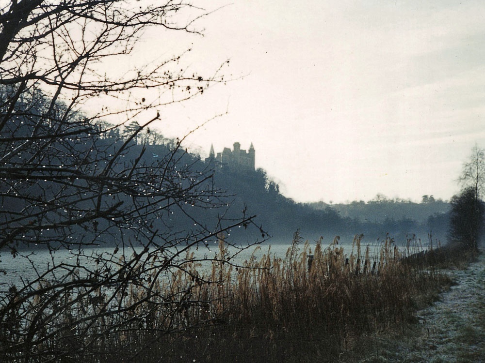 Alton Castle, viewed from far bank of river Churnet on a winter morning