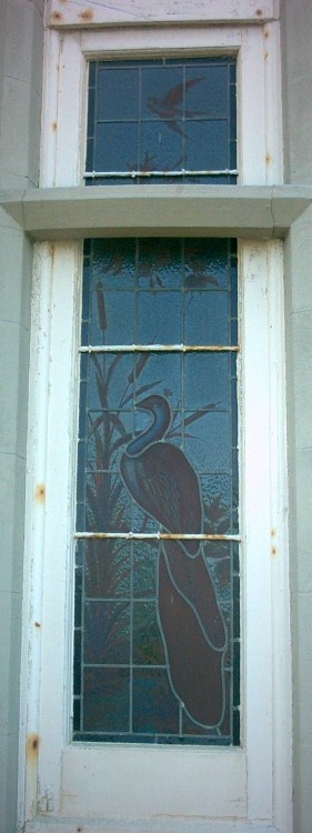 Broadstairs. Stained glass window of Bleak House. Unfortunately the second of the pair is damaged.