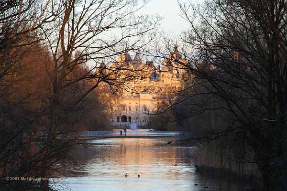 Evening view from Buckingham Palace along the lake in St James Park to Whitehall and Horseguards.