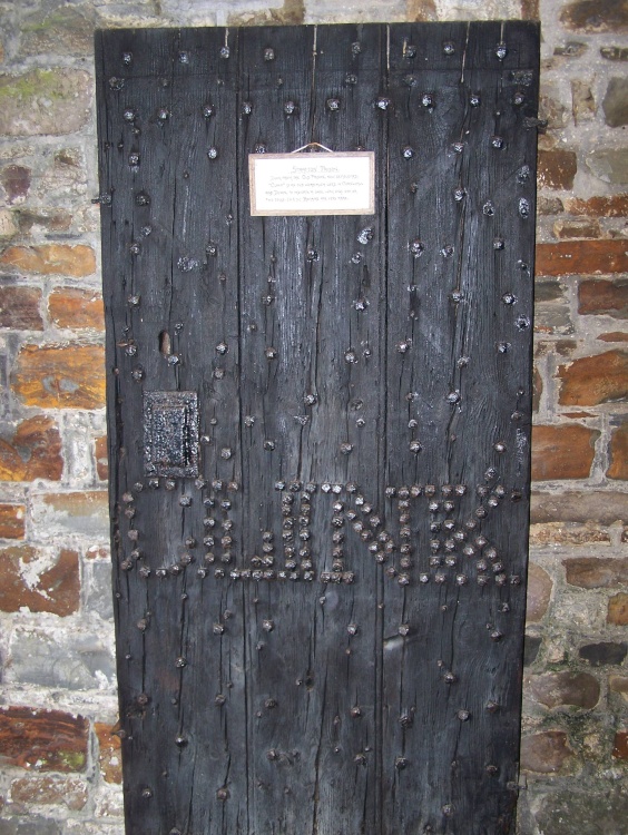 The old prison door found in the porch of st Andrews church, Stratton, Cornwall, England