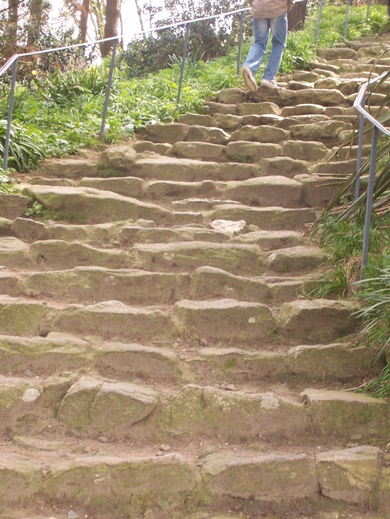 The pilgrim steps up to the summit of St. Michael's Mount