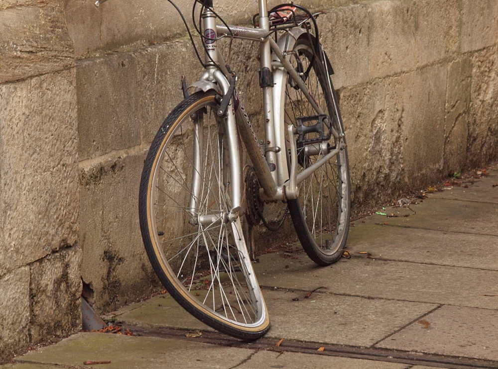Bent bike, against the wall of Jesus College, Oxford
