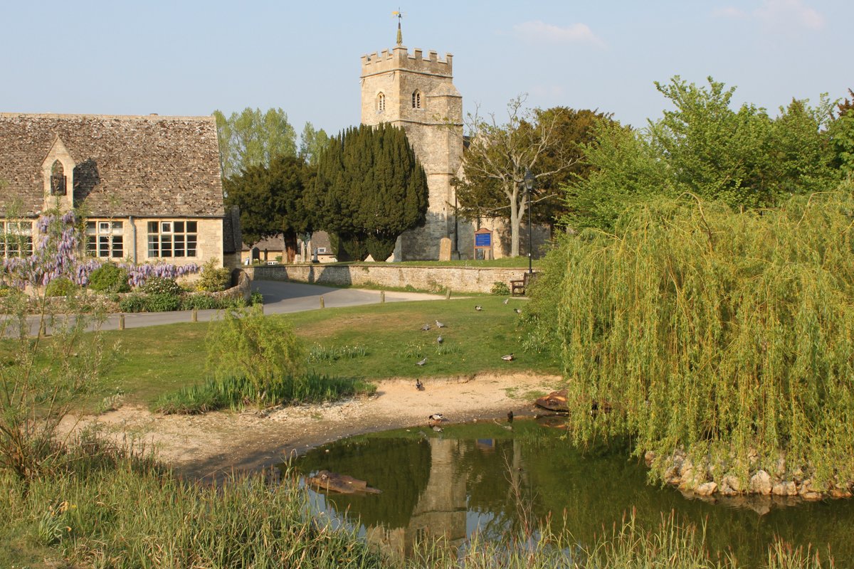 The duck pond, Ducklington, with St. Bartholomew's Church behind