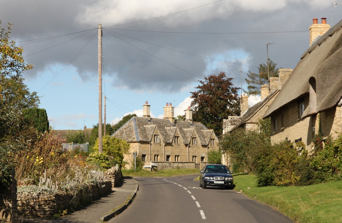 The main road at Spelsbury, with the almshouses in the background
