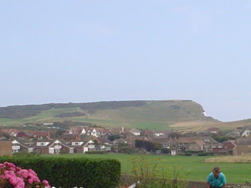A picture taken walking along a road in Seaford. Beachy Head is in the background.