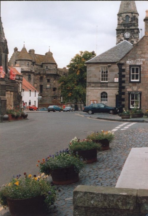 Falkland Palace, top left, Town Hall and floral bordered street, Falkland, Fife.