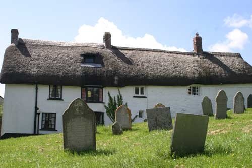 Traditional Devon cottages backing onto churchyard in Zeal Monachorum, Devon