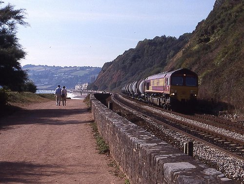 A freight train trundles along the sea wall at Teignmouth, Devon in September 2002.
