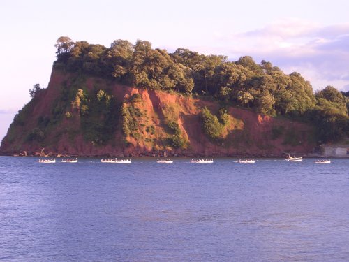 Rowers entering harbour past The Ness