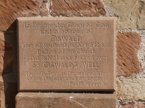 ST OSWALD,CHURCH PLAQUE ON END OF CHURCH.Kirkoswald,Cumbria.