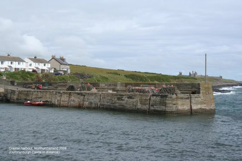 Craster harbour with Dunstanburgh Castle in the background