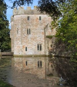Reflection of the Gatehouse in the moat. The Bishops Palace, Wells.