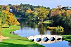 Autumn View of the 5 Arch Bridge & Gothic Temple at Painshill Park in Cobham, Surrey